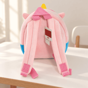 Pink plush backpack on a child's desk
