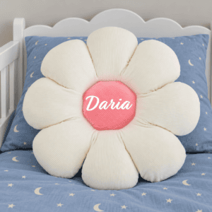 White flower cushion on blue toddler bed