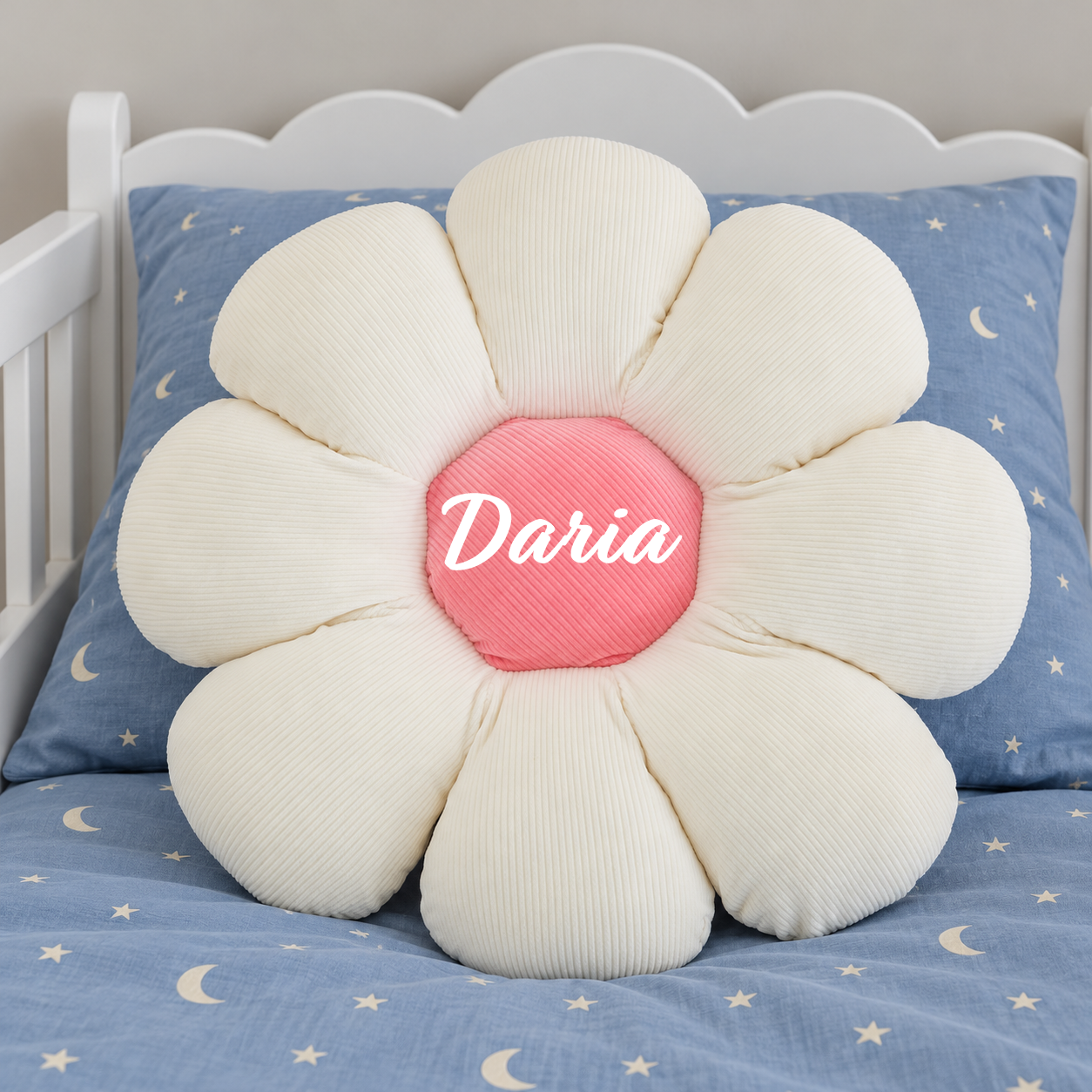 White flower cushion on blue toddler bed